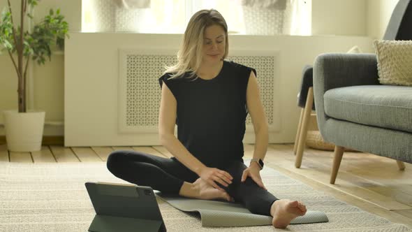 Female Flexible Fitness Training Woman in Sitting Legs Apart Position Stretches