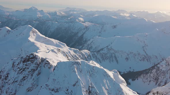 Aerial View From an Airplane of Beautiful Snowy Canadian Mountain Landscape alt