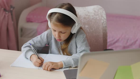 Schoolgirl Girl Studies Online On Laptop At Home