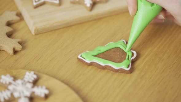 Close-up of a woman decorating a homemade gingerbread Christmas tree