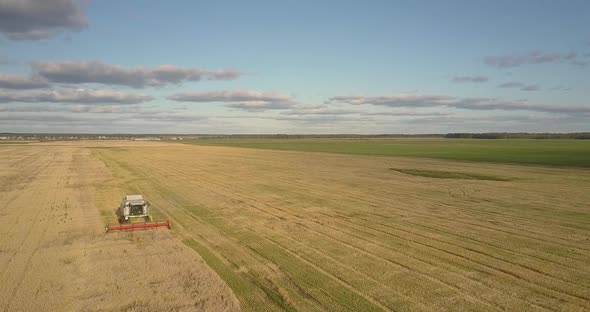 Aerial Landscape with Gold Field and Operating Harvester alt