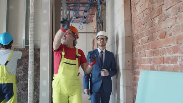 Foreman Builder and Construction Worker in Indoor Apartment alt