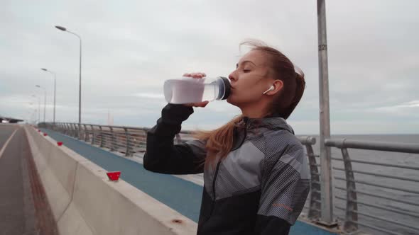 Sporty Woman Drinking Water alt