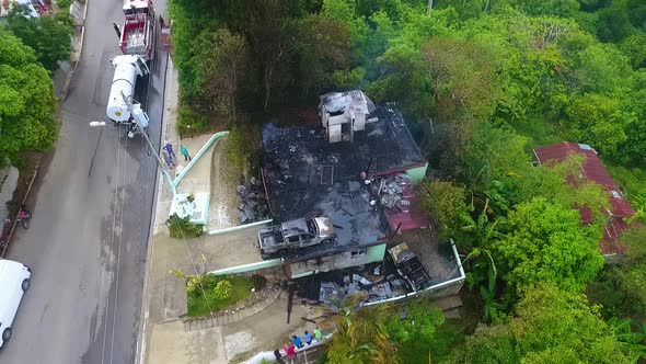 Aerial view around a burnt down house fire, in rural Mexico - circling, drone shot alt