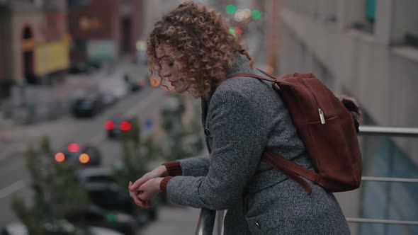 A Girl Stands on the Balcony Dreaming and Thinking About the Future alt
