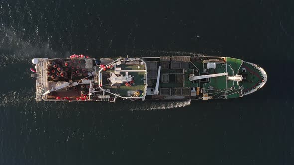 View From the Drone Vertically Down on a Fishing Trawler at Sea on the Move alt