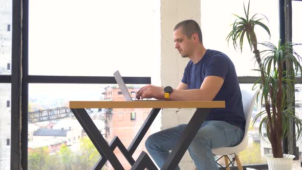 Man Working on Laptop in Office or Coworking