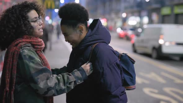 slow motion of two multiethnic women making peace hugging alt