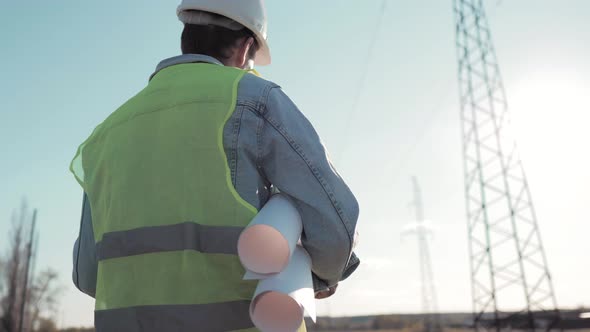 Architect Worker Checking Construction Project On Electric Tower alt