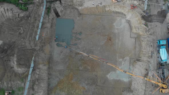 A pump pouring concrete at the construction site alt