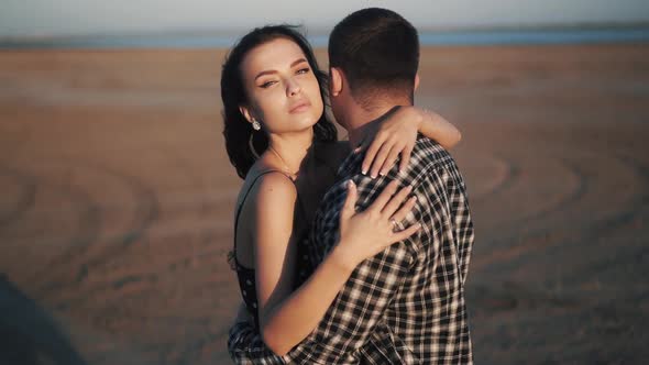 Close Up Slowmotion Video of Young Couple Hugs in a Sandy Plane alt