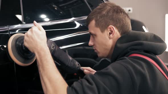 Process of Accurate Polishing of a Black New Car alt