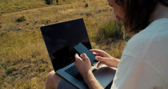Young Adult Man Using Smartphone Browsing and Sliding with Finger on Screen alt