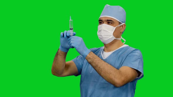 Asian Doctor In Mask Preparing A Syringe For Injection on Green Screen