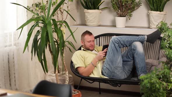 Man Using Phone Browsing Smartphone Apps Looking at Screen Male