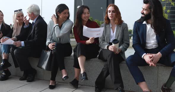 Multiethnic business people working outdoor from office alt