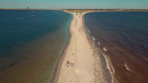Aerial Top View Tourist Couple Walking By Sand Bar of Tiligul Regional Landscape Park of Mykolaiv alt