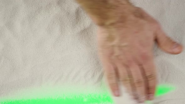 Man's Hand is Clearing the Sand Demonstrating Advertising Area Workspace Mock Up alt