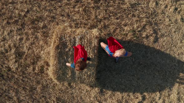 Top View of Dad with Son As Superheroes Outdoors alt