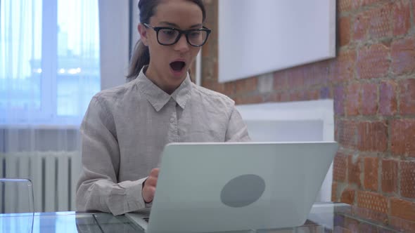 Hispanic Woman Celebrating Online Success, Achieving Goal alt