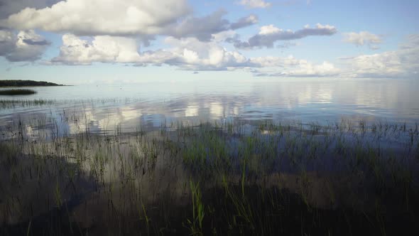 Clouds reflect on the waves of the Baltic in summer