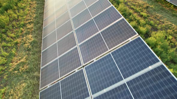 Aerial View of Solar Farm on the Green Field at Sunset Time Solar Panels in Row alt