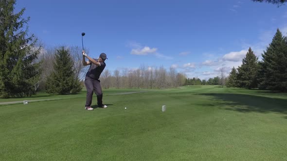 golf player tees off and watches his shot 4k approach smooth gimbal alt
