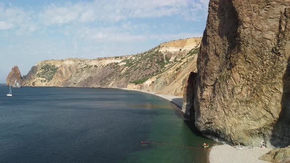 Aerial View From Above on Calm Azure Sea and Volcanic Rocky Shores alt