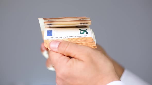 Man Holding 50 Euro Banknotes
