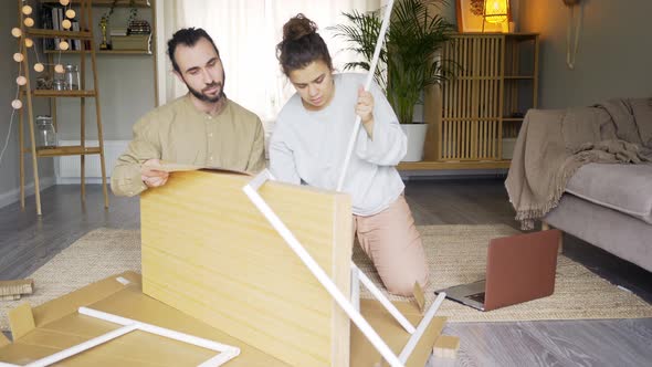 Man Assist Woman Assemble Furniture at Home