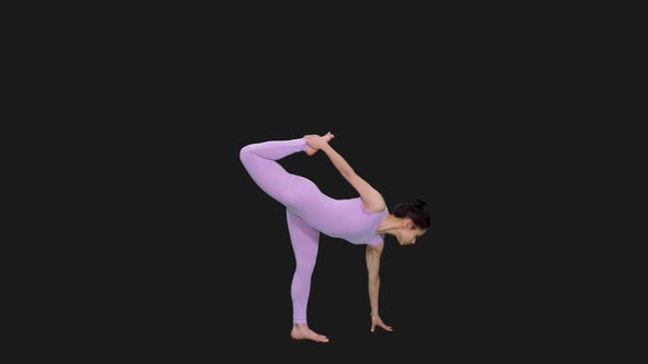 Young Woman Doing Half Moon Pose while Practicing Yoga, Alpha in