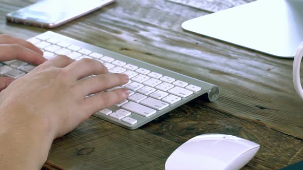 A Caucasian Male Typing on a Wireless Keyboard 02 alt