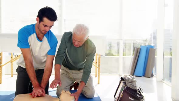 Male paramedics during cardiopulmonary resuscitation training alt