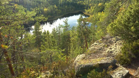 Landscape with Trees, Rocks and Lake. Gimbal Shot of Nature Autumn Landscape in Repovesi National alt