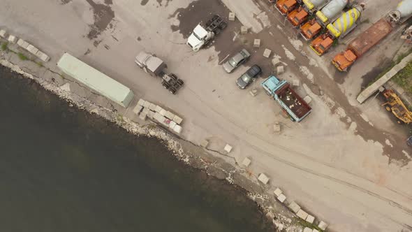 Overhead Top Down Aerial View Following a Truck Without a Trailer Arriving Into the Harbor Parking alt