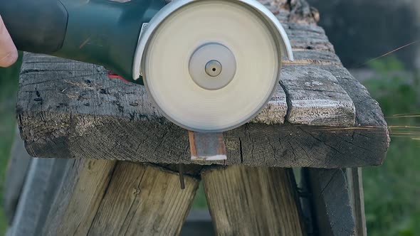 Slow Motion Closeup Piece of Metal Cut By Disk Saw Outdoors alt