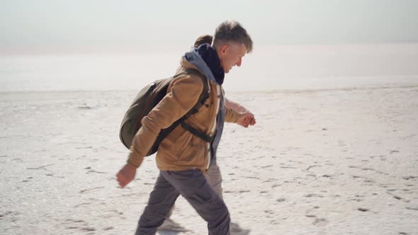 Happy Lovely Couple Millenial Hipsters Walking Hand to Hand and Joyfully Running on Pink White Salty alt