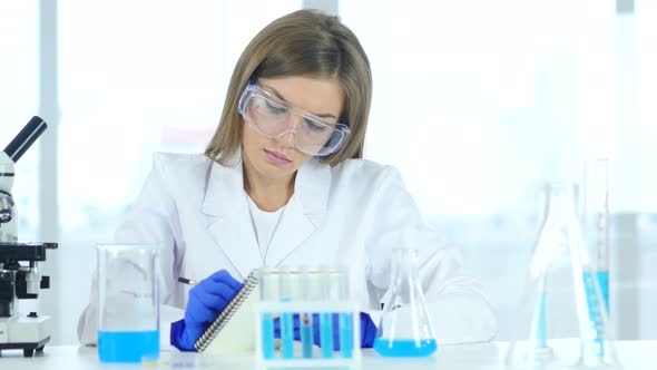 Doctor, Scientist Writing Details, Result of Research in Laboratory alt