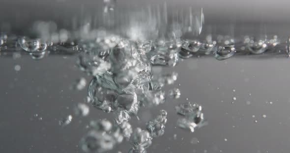 Water Surface With Bubbles Rising And Forming As Liquid Is Added alt