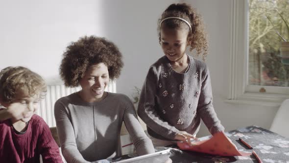 Mother video call with children and father on digital tablet