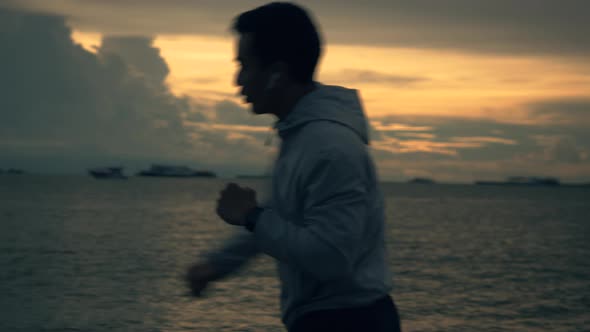 Silhouette of a boxer young Asian man is practicing boxing workout. alt