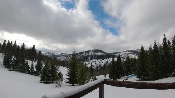 Timelapse clouds floating the sky. Snowed hills and mountains. Winter time. alt