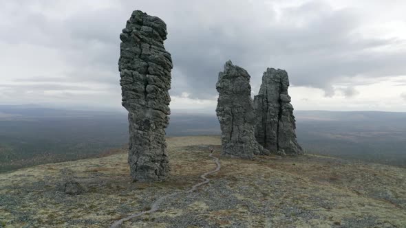 High rocks rising up on cloudy sky background, beauty of nature alt