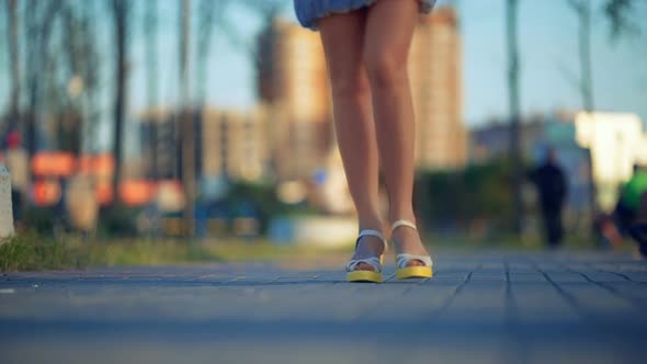 Close Up of Young Women Feet Walking on Street alt