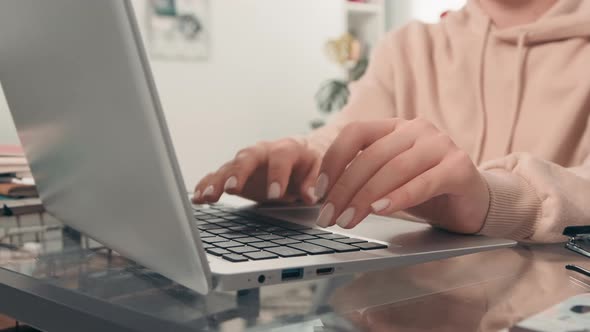 Young Woman Typing on Laptop alt