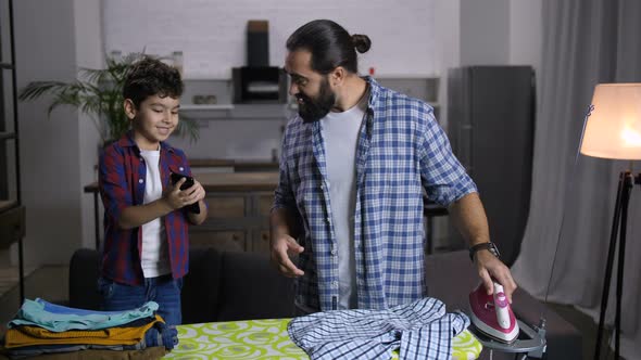 Single Handsome Father Ironing Clothes at Home alt
