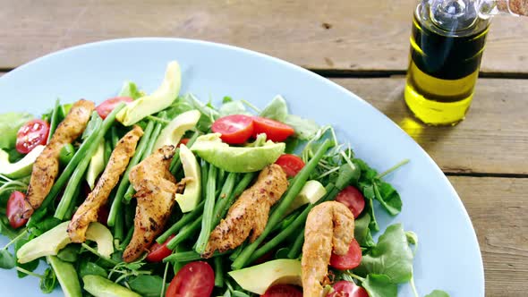 Salad with oil in plate alt