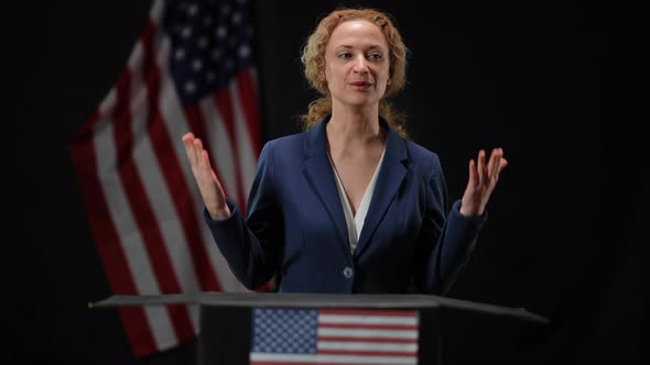 Confident Positive Politician Woman Presenting Campaign From Tribune Talking and Gesturing alt