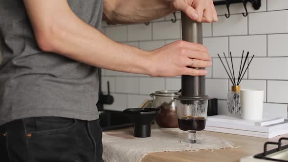 Barista Makes Aeropress Step By Step. Squeeze Out Coffee alt