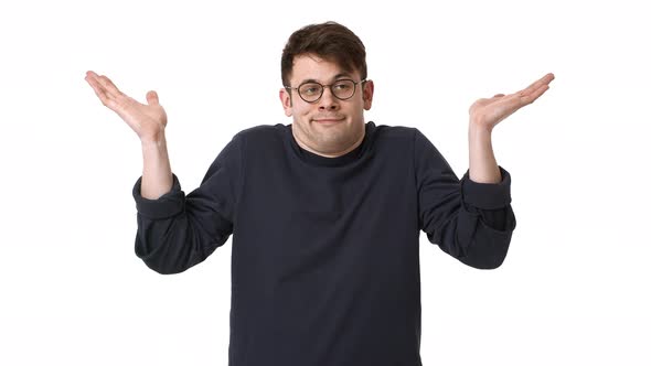 Portrait of Confused Man Wearing Black Sweatshirt and Eyeglasses Shrugging and Throwing Up Hands alt